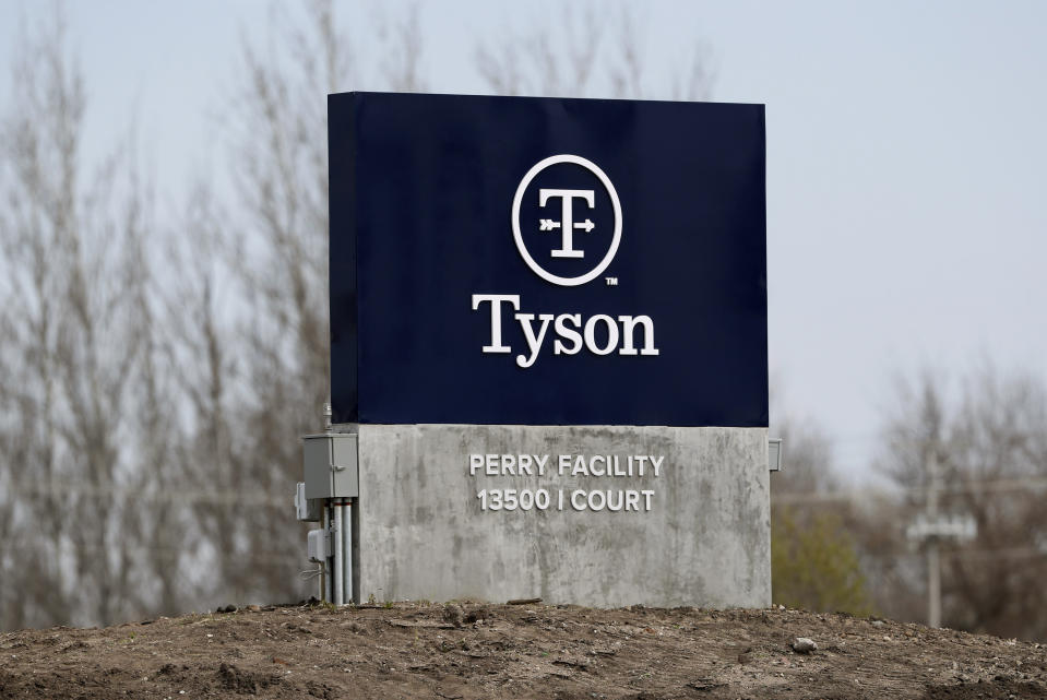 In this April 22, 2020, file photo, a sign sits in front of the Tyson Foods pork plant in Perry, Iowa. A group of worker advocacy organizations has filed a civil rights complaint with the U.S. Department of Agriculture alleging that meat processing companies Tyson and JBS have engaged in workplace racial discrimination during the coronavirus pandemic. The complaint alleges the companies adopted polices that reject U.S. Centers for Disease Control and Prevention guidance on distancing and protective gear on meat processing lines. The complaint says the operating procedures have a discriminatory impact on mostly Black, Latino, and Asian workers. (AP Photo/Charlie Neibergall, file)