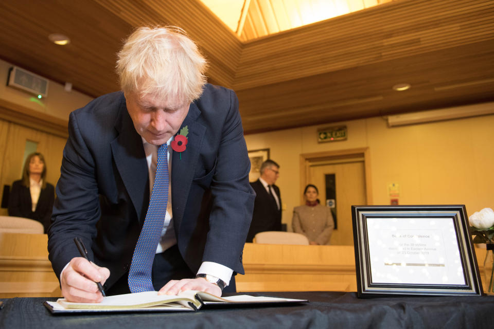 Prime Minister Boris Johnson signs a book of condolence, during a visit to Thurrock Council Offices in Essex after the bodies of 39 people were found in a lorry container last week.