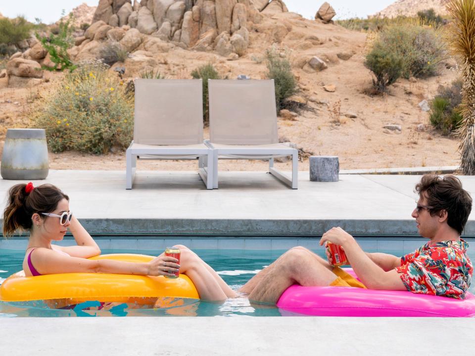 Cristin Milioti and Andy Samberg float on inner tubes in a pool in "Palm Springs"