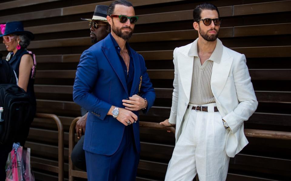 Guests seen wearing navy suit, white suit at the Pitti Immagine Uomo 102 at Fortezza Da Basso on June 16, 2022 in Florence, Italy - Christian Vierig/Getty Images