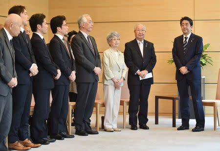 Japan's Prime Minister Shinzo Abe (R) meets family members of victims abducted to North Korea at the Prime Minister's official residence in Tokyo, Japan, June 14, 2018. Kazuhiro Nogi/Pool via Reuters