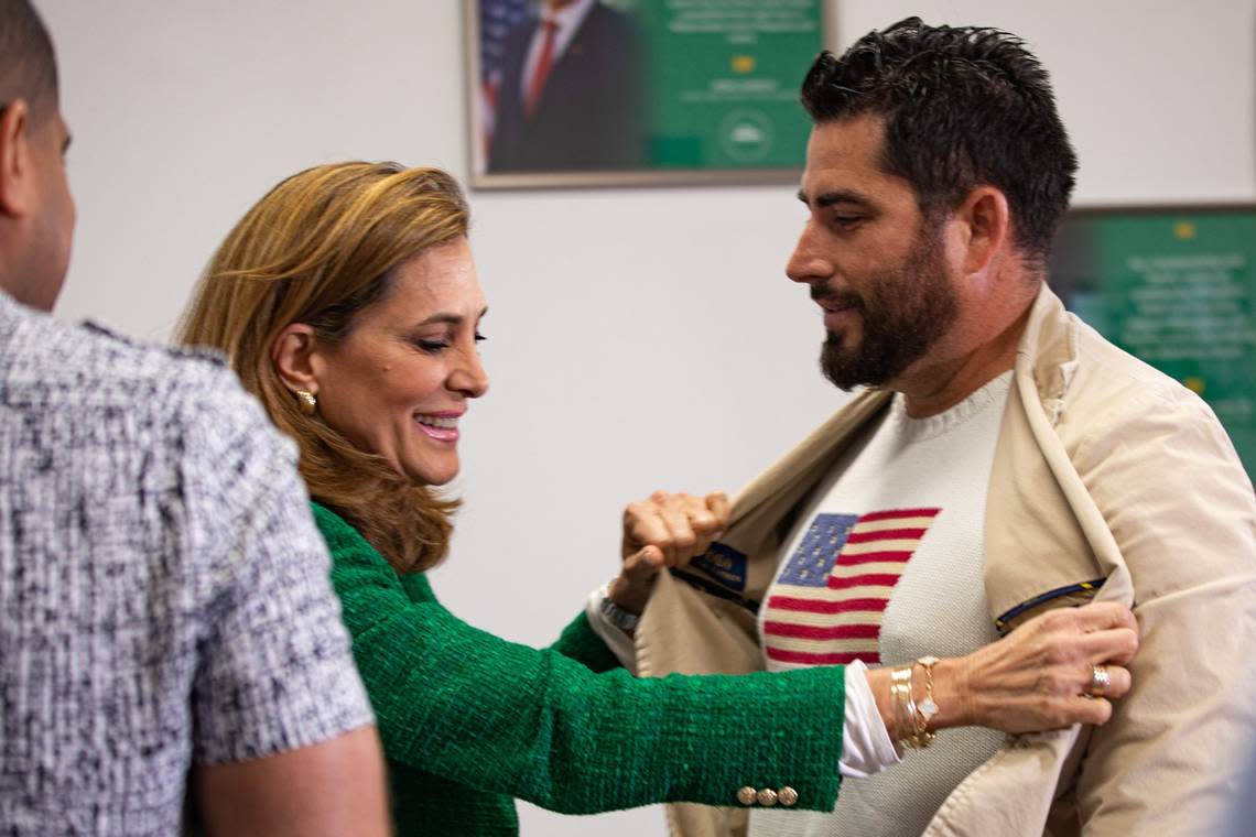 U.S. Rep. Maria Elvira Salazar looks at the American flag on Josel Martinez’s shirt while visiting the RNC Hispanic Community Center in Doral on Tuesday, Oct. 4, 2022.
