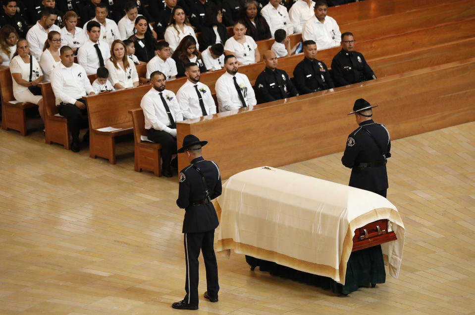 Officers flank the casket of slain Los Angeles Police Officer Juan Jose Diaz during his Funeral Mass at the Cathedral of Our Lady of the Angeles Monday, Aug. 12, 2019 with Archbishop Jose H. Gomez presiding at the bilingual Mass. (Al Seib/Los Angeles Times via AP)