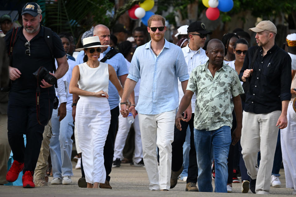 Britain's Prince Harry (C), Duke of Sussex, and his wife Meghan Markle (2nd L) arrive at San Basilio de Palenque, Bolivar department, Colombia, on August 17, 2024. Prince Harry and his wife, American actress Meghan Markle, arrived in Colombia at the invitation of Colombia's vice-President Francia Marquez, with whom they will attend various meetings with women and young people to reject discrimination and cyberbullying. (Photo by RAUL ARBOLEDA / AFP) (Photo by RAUL ARBOLEDA/AFP via Getty Images)