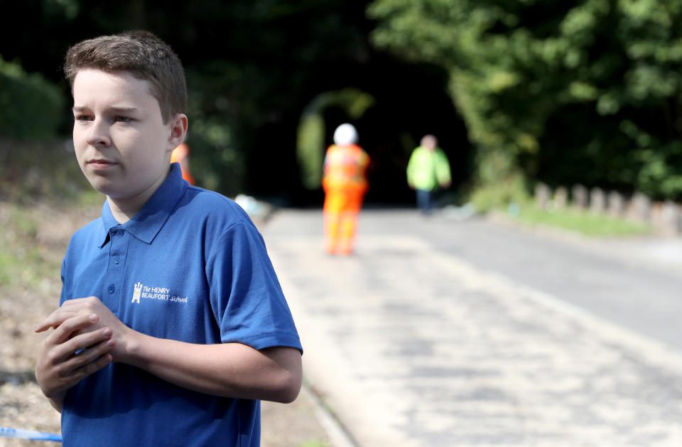 Jake Coates, 14, a pupil at Henry Beaufort School at the scene on Well House Lane in Winchester after the school bus he was travelling in crashed into a railway bridge causing 'significant damage' to the top of the double-decker bus. Three children were taken to hospital with serious injuries while 12 others suffered minor injuries after the school bus they were travelling in crashed into a railway bridge causing 'significant damage' to the top of the double-decker bus.