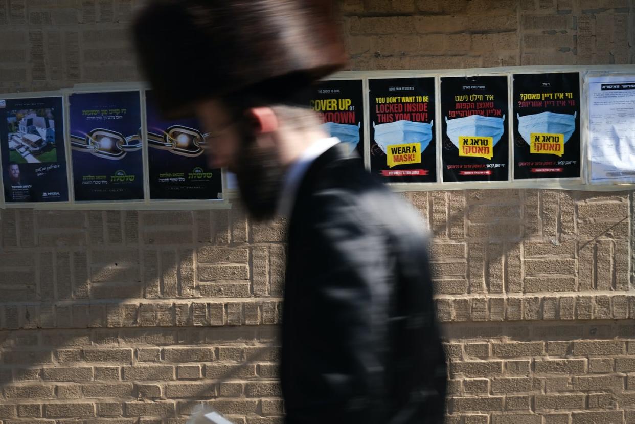 <span class="caption">COVID-19 has spiked in ultra-Orthodox Jewish parts of New York City.</span> <span class="attribution"><a class="link " href="https://www.gettyimages.com/detail/news-photo/person-walks-through-the-brooklyn-neighborhood-of-borough-news-photo/1278637895?adppopup=true" rel="nofollow noopener" target="_blank" data-ylk="slk:Spencer Platt/Getty Images;elm:context_link;itc:0;sec:content-canvas">Spencer Platt/Getty Images</a></span>