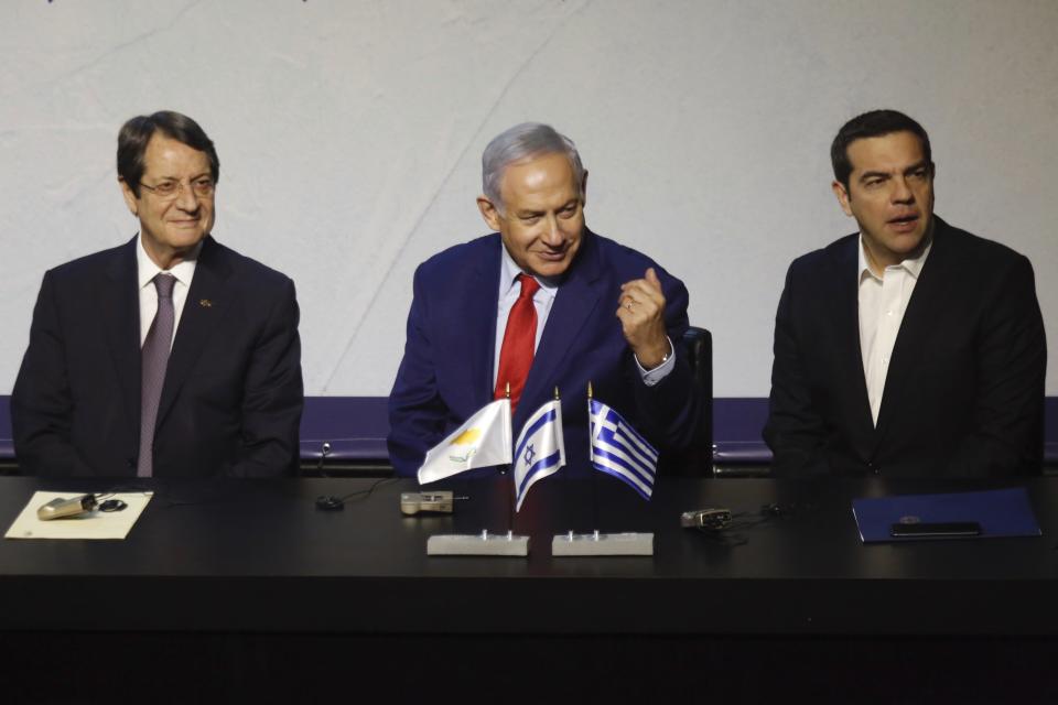 Greek Prime Minister Alexis Tsipras, right, Cypriot President Nicos Anastasiades, left, and Israeli Prime Minister Benjamin Netanyahu meet during the 5th trilateral summit with Israel, Greece and Cyprus in Beersheba, Israel, Thursday, Dec. 20, 2018. (AP Photo/Ariel Schalit)