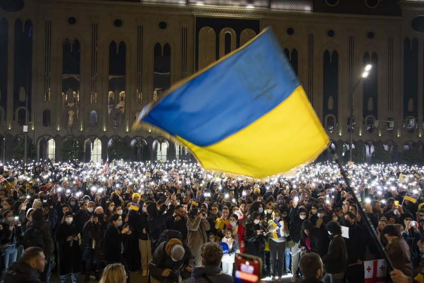 TBILISI, GEORGIA - FEBRUARY 25: People gather for a rally in support of Ukraine in front of parliament, protesting the war in Ukraine and demanding the Georgian Prime Minister, Irakli Gharibashvili, to step down, after he said he would not introduce sanctions against Russia in response to its invasion of Ukraine on February 25, 2022 in Tbilisi, Georgia. Russia began a large-scale attack on Ukraine yesterday with Russian troops invading the country from the north, east and south, accompanied by air strikes and shelling. The Ukrainian president said that at least 137 Ukrainian soldiers were killed by the end of the first day. (Photo by Daro Sulakauri/Getty Images)
