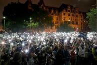 <p>Protesters stand outside of the St. Louis city jail on Monday, Sept. 18, 2017. The protesters chanted “free our people” outside the jail on Monday night to show solidarity with those who remain behind bars. Police said that more than 120 people were arrested during Sunday’s protests. Monday was the fourth day of protests over the acquittal of a white former police officer in the killing of a black suspect. (Photo: David Carson/St. Louis Post-Dispatch via AP) </p>