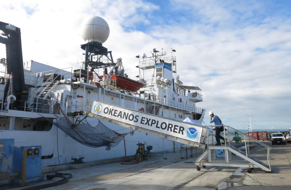 A member of a scientific team boards the Okeanos Explorer ship of the U.S. National Oceanic and Atmospheric Administration, in San Juan, Puerto Rico, Monday, Oct. 29, 2018. Scientists will analyze coral and fish habitats as well as map geological features, exploring new sites in deep waters around Puerto Rico and the U.S. Virgin Islands as part of the 22-day mission. (AP Photo/Danica Coto)