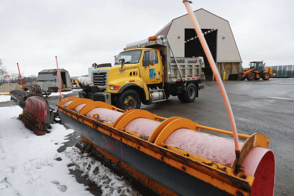 A Pennsylvania Department of Transportation road treatment truck pulls in to attach a plow at a storage facility in Franklin Park, Pa. on Friday, Jan. 18, 2019. Weather forecasters are are predicting a heavy weekend snow storm across Pennsylvania and surrounding states. (AP Photo/Keith Srakocic)