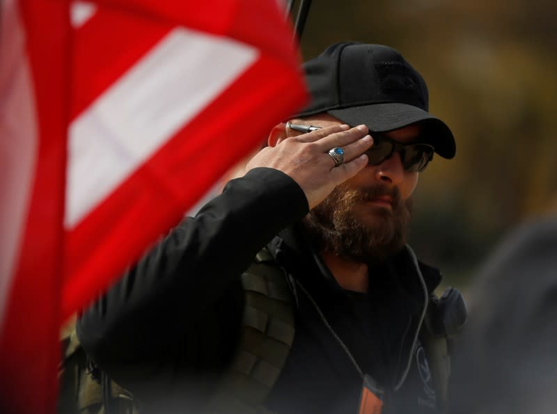 A pro-gun rights activist participating in the "Declaration of Restoration" salutes in Washington, D.C.