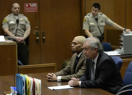 Singer Chris Brown (center L) and his attorney Mark Geragos (center R) appear in court during a probation violation hearing in which his probation was revoked at Los Angeles Superior Court in Los Angeles, December 16, 2013. REUTERS/Kevork Djansezian/Pool