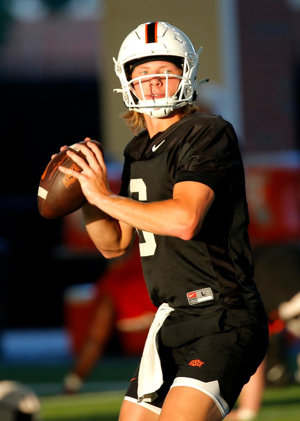 Oklahoma State quarterback Zane Flores looks to throw a pass during an Oklahoma State University football practice in Stillwater, Okla., Wednesday, Aug., 2, 2023.