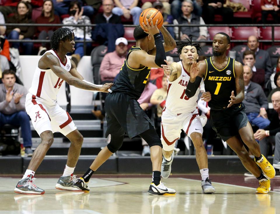 Missouri guard Jarron Coleman (5) tries to pass to Missouri guard Amari Davis (1) and is defended by Alabama guard Keon Ellis (14) and Alabama guard Jahvon Quinerly (13) in Coleman Coliseum Saturday, Jan. 22, 2022. 