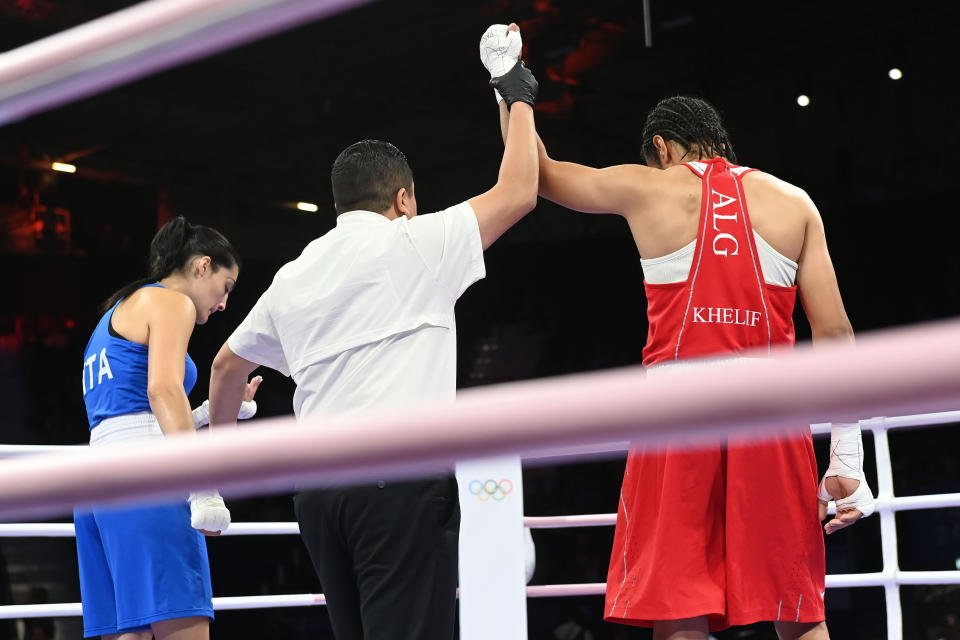 PARIS, FRANCE - AUGUST 1: Algeria's Imane Khelif (in red) during  the Women's 66kg preliminary round match against Angela Carini of Italy (in blue) on day six of the Olympic Games Paris 2024 at North Paris Arena on August 01, 2024 in Paris, France. (Photo by Fabio Bozzani/Anadolu via Getty Images)