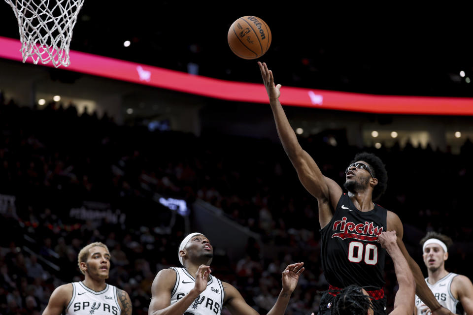 Portland Trail Blazers guard Scoot Henderson shoots against the San Antonio Spurs during the first half of an NBA basketball game Friday, Dec. 29, 2023, in Portland, Ore. (AP Photo/Howard Lao)