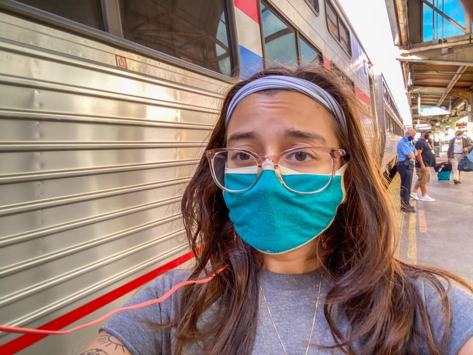 The author wears a mask outside of an Amtrak train