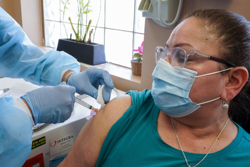 Registered nurse Anna Yadgaro inoculates Juana Mejia with the Moderna COVID-19 vaccine, Wednesday, May 12, 2021, at the Joseph P. Addabbo Family Health Center in the Far Rockaway neighborhood of the Queens borough of New York. (AP Photo/Mary Altaffer)