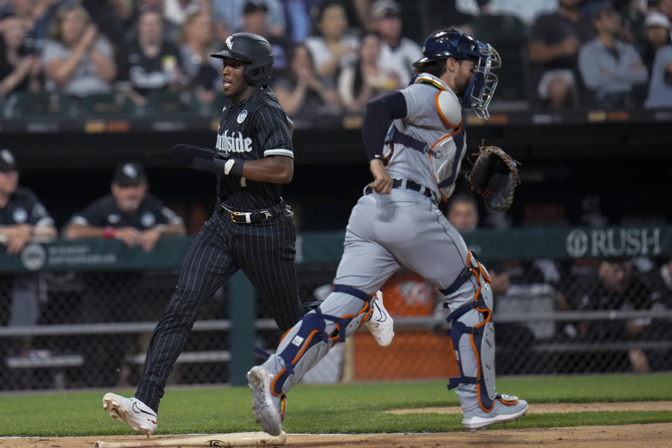 Chicago White Sox's Tim Anderson, left, jogs past Detroit Tigers catcher Eric Haase to score during the sixth inning of a baseball game Friday, June 2, 2023, in Chicago. (AP Photo/Erin Hooley)
