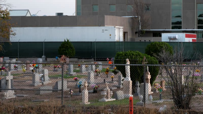 Refrigerated trailers are seen parked at the rear of the El Paso County Office of the Medical Examiner in El Paso