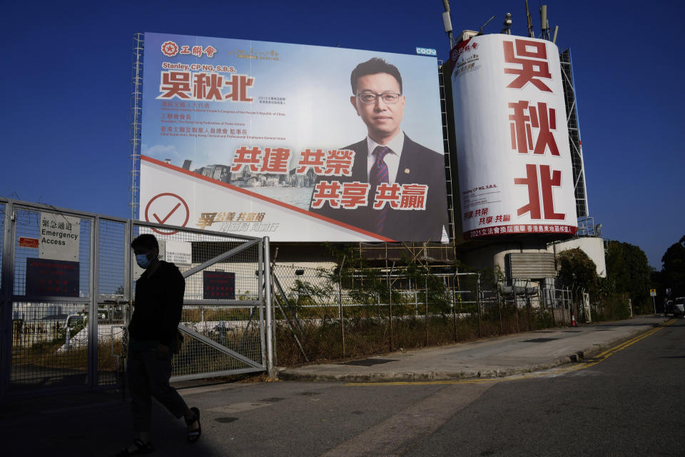 A billboard promoting pro-Beijing legislative election candidate Stanley Ng Chau-pei, is displayed on a road in Hong Kong on Dec. 11, 2021. Hong Kong voters are preparing to vote for the first time this weekend since election laws were changed, amid a dearth of opposition candidates months after the city began cracking down on dissent. The legislative elections will be held on Sunday, Dec. 19, 2021. (AP Photo/Kin Cheung)