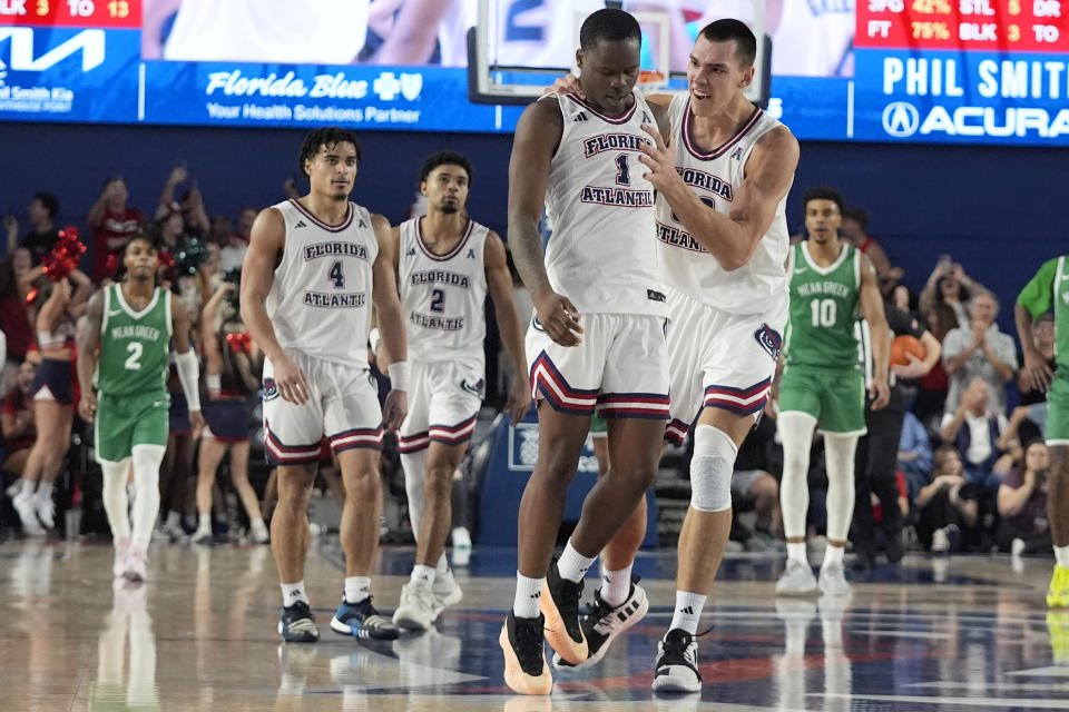 Florida Atlantic center Vladislav Goldin, right, congratulates guard Johnell Davis (1) after Davis hit the winning shot during the final seconds of the second half of an NCAA college basketball game against North Texas, Sunday, Jan. 28, 2024, in Boca Raton, Fla. (AP Photo/Wilfredo Lee)