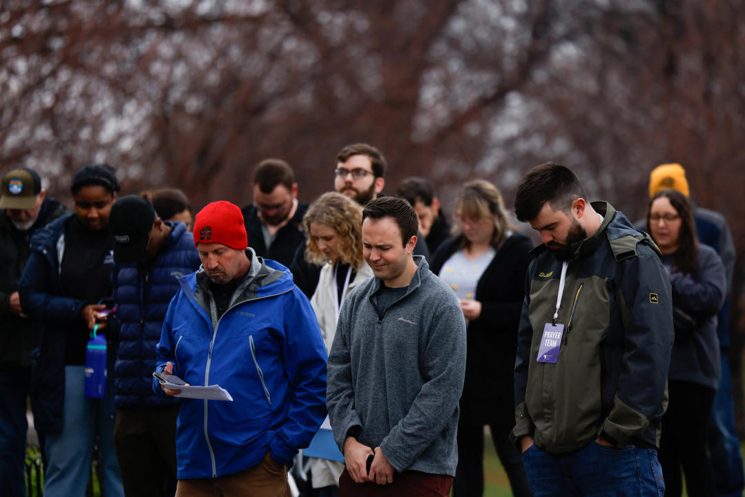 People outdoors for a prayer vigil.