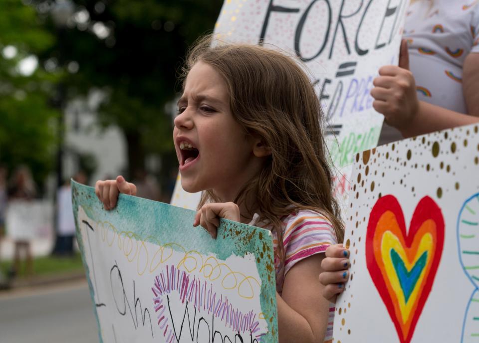 8-year-old Oona Path holds up her sign to passing cars as she chants from the sidewalk of Riverside Drive during the Rally for Abortion Rights held at the Four Freedoms Monument in Evansville, Ind., Sunday afternoon, May 22, 2022.