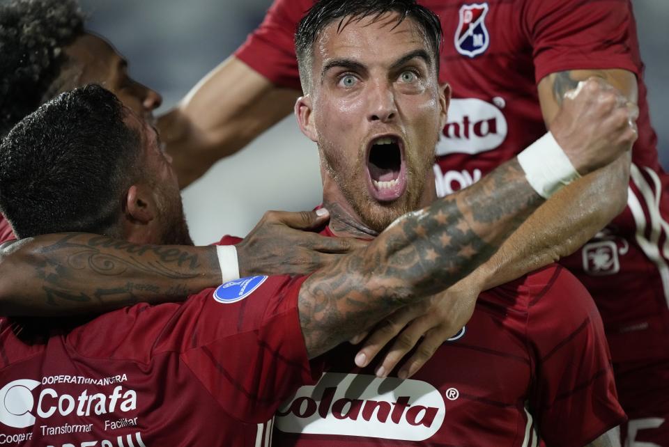 Oscar Mendez of Colombia's Independiente Medellin celebrates with his teammate Adrian Arregui after Arregui scored his side's 2nd goal against Paraguay's Guairena FC during a Copa Sudamericana soccer match at Defensores del Chaco stadium in Asuncion, Paraguay, Thursday, April 7, 2022. (AP Photo/Jorge Saenz)