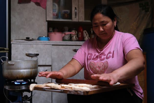 Ishtsooj Davagdorj rolls out dough to fry for a cookie-like biscuit called boortsog, a Mongolian staple, one evening in October.