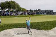 Russell Henley reacts after making his birdie shot from the bunker on the 11th green during the third round of the U.S. Open Golf Championship, Saturday, June 19, 2021, at Torrey Pines Golf Course in San Diego. (AP Photo/Jae C. Hong)