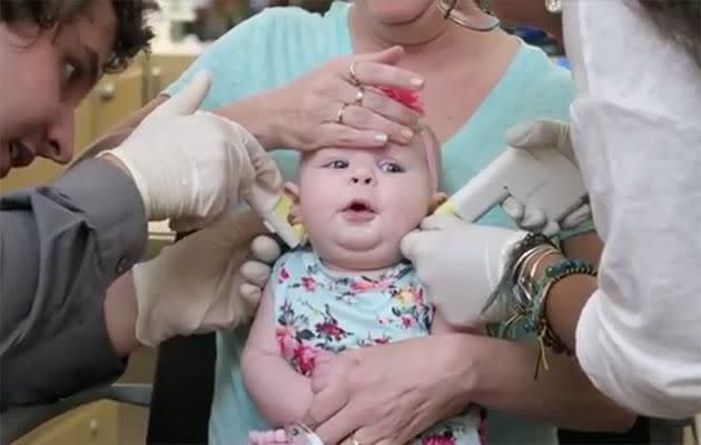 A mother has been slammed for this video of her four-month-old baby's ears being pierced. Photo: Facebook