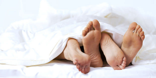 Close-up of the feet of a couple on the bed (Photo: )