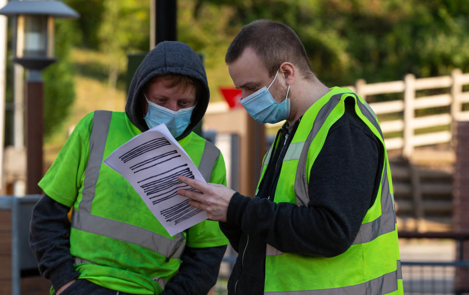 BLACKWOOD, WALES - JUNE 2: Staff wearing PPE check over a delivery list at Mcdonlad's as they prepare to resume trading for takeaway only in Wales within the next 24 hours following lockdown on June 2, 2020 in Blackwood, Wales, United Kingdom. The British government continues to ease the coronavirus lockdown by announcing schools will open to reception year pupils plus years one and six from June 1st. Open-air markets and car showrooms can also open from the same date. (Photo by Huw Fairclough/Getty Images)