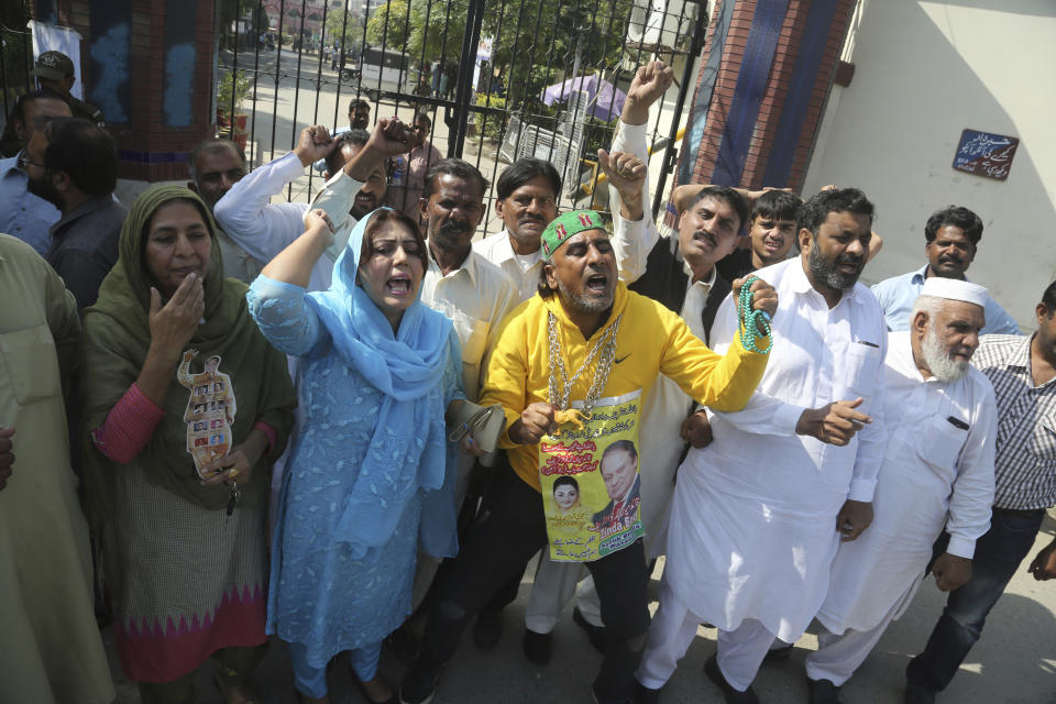 Supporters of Pakistani former Prime Minister Nawaz Sharif shout anti-government slogans outside a hospital in Lahore, Pakistan, Tuesday, Oct. 22, 2019. Sharif, who was convicted on corruption charges, has been rushed to hospital from the prison after recent blood tests raised doctors' concerns. (AP Photo/K.M. Chaudary, File