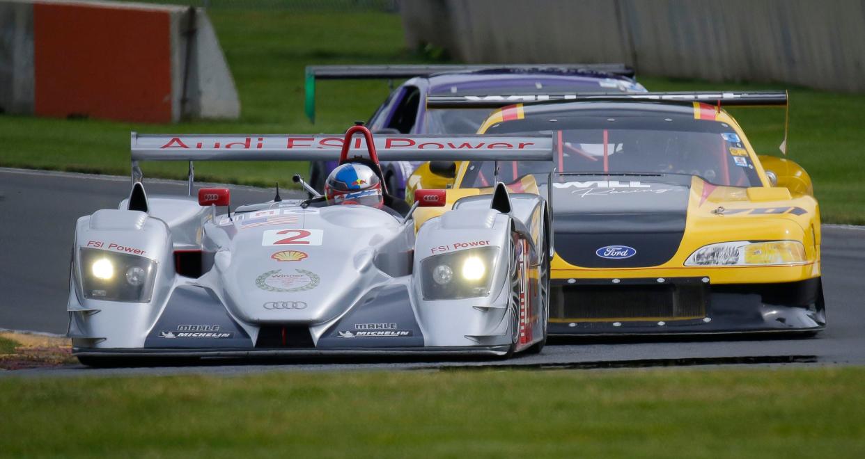 A closed wheel Audi leads a pair of Ford Mustangs during Ariens Art on Wheels, Saturday, September 16, 2023, at Road America near Plymouth, Wis.