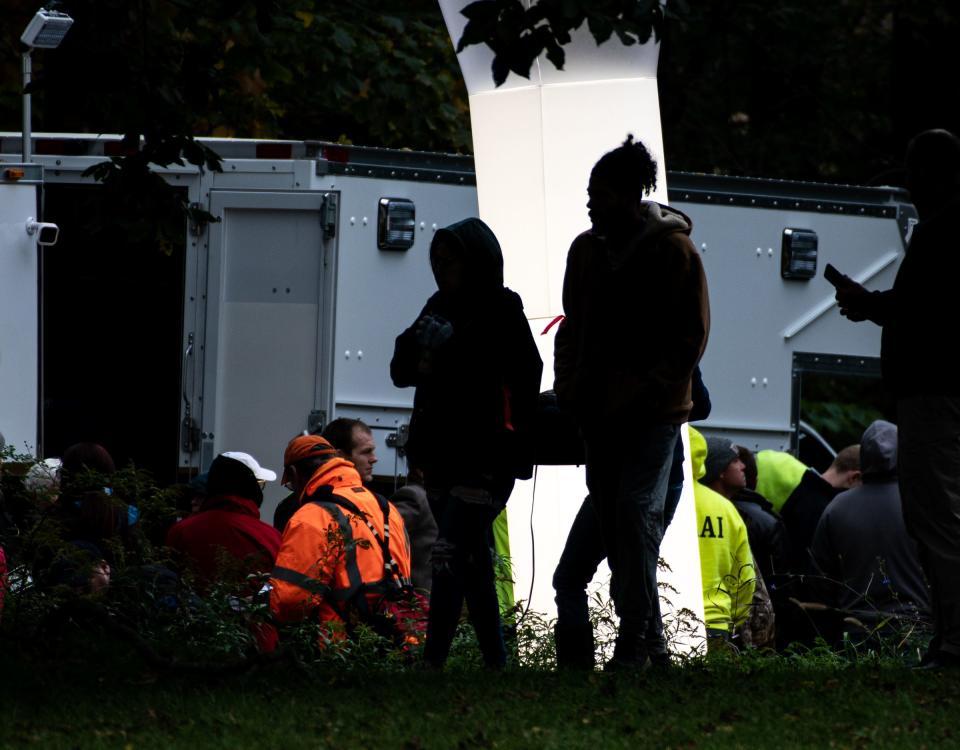 Victoria and Brandon Jones, the parents of 2-year-old Jermaine, silhouetted against a light near a police command center. First responders and volunteers searched the area for their missing toddler for about 28-hours. The search ended tragically late Tuesday afternoon when Jermaine's body was pulled from the Looking Glass River.