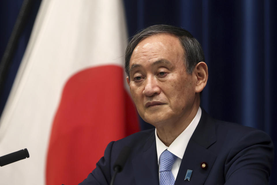 Japan's Prime Minister Yoshihide Suga speaks during a press conference at the prime minister's official residence Friday, May 28, 2021, in Tokyo. Japan extended a coronavirus state of emergency in Tokyo and other areas for 20 more days on Friday, with infections still not slowing as it prepares to host the Olympics in just over 50 days. (Behrouz Mehri/Pool Photo via AP)