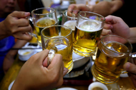 FILE PHOTO: People drink beer in a restaurant in Hanoi, Vietnam, April 17, 2017. REUTERS/Kham/File Photo