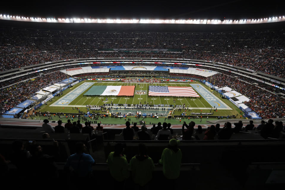 The flags of Mexico and the United States cover the field before an NFL football game between the Los Angeles Chargers and the Kansas City Chiefs Monday, Nov. 18, 2019, in Mexico City. (AP Photo/Eduardo Verdugo)