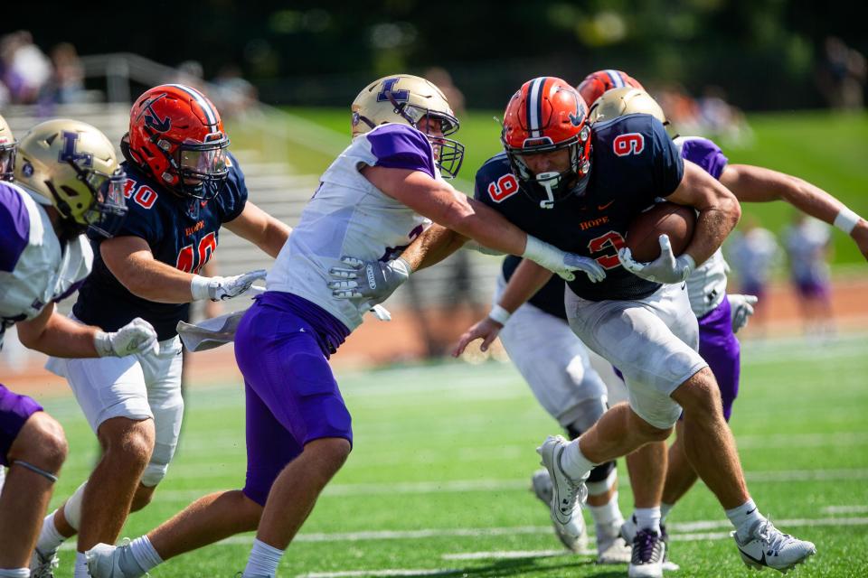 Hope's Chance Strickland stiff arms the defender Saturday, Sept. 9, 2023, at Hope's Ray and Sue Smith Stadium.