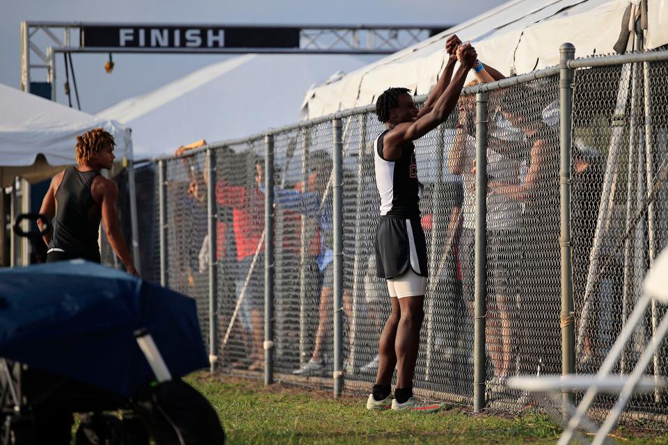 Columbia's Seth Stockton embraces a familiar person after completing in the triple jump Friday, May 19, 2023 during the FHSAA Class 3A Track & Field State Championships at the University of North Florida’s Hodges Stadium in Jacksonville, Fla. Stockton  placed first with 14.55 meters. 