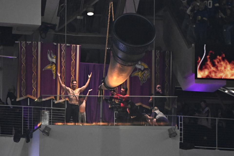 Kirk Cousins and his son fire up the crowd prior to the game against the Green Bay Packers at U.S. Bank Stadium.