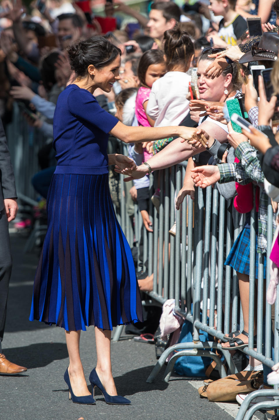 <p>Wearing a bespoke Givenchy jumper and pleated skirt, the Duchess of Sussex stuck to her favourite colour palette while on a walkabout in Rotorua. <em>[Photo: Getty]</em> </p>