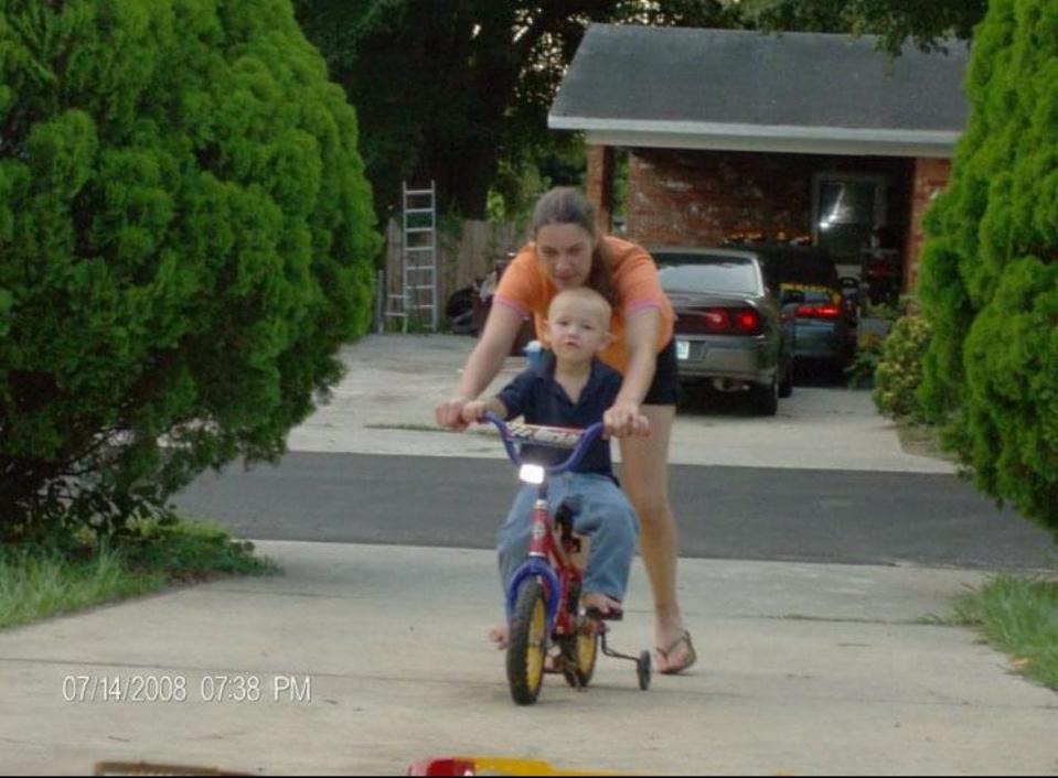 Zach Clabough is shown learning to ride a bicycle with help from his mother, Barbara Runyon. Zach, 18, died Wednesday in a hit-and-run crash as he walked to Bartow High School.