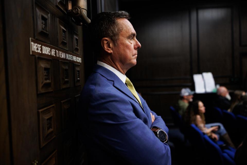 El Dorado County District Attorney Vern Pierson, in blue suit and yellow tie, stands in a courtroom.