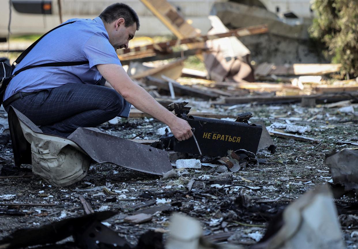 A war crimes prosecutor works at a site of a Russian drone attack, amid Russia's attack on Ukraine, on the outskirts of Lviv, Ukraine on June 19, 2024.