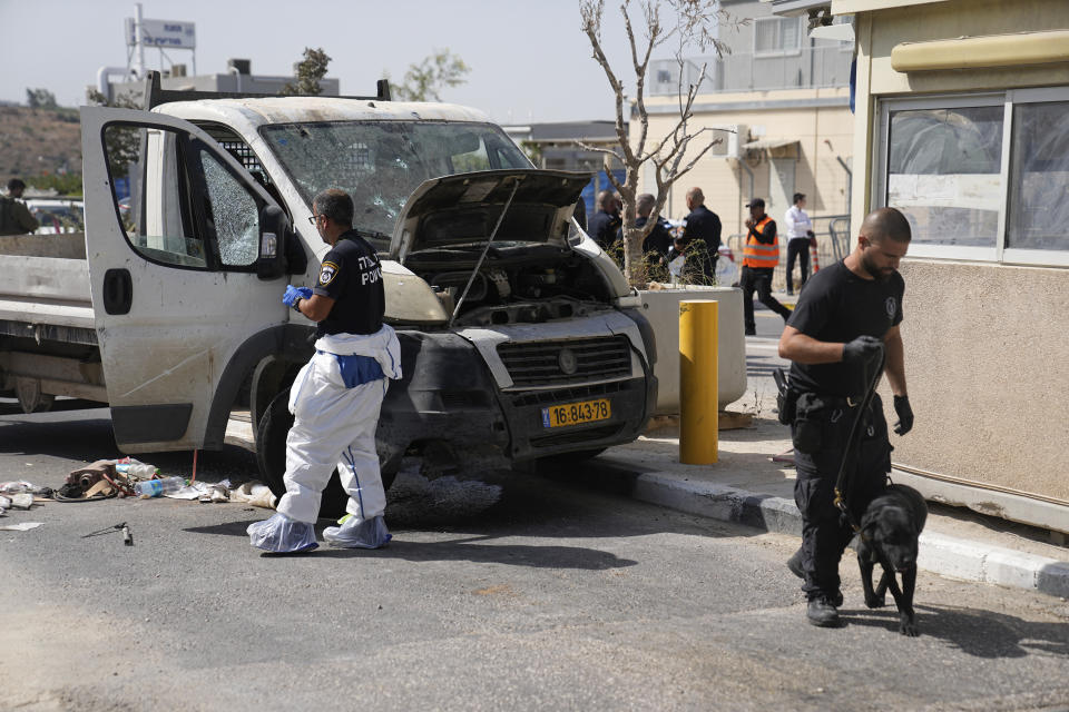 Israeli security forces inspect the scene of a Palestinian ramming attack near West Bank Maccabim checkpoint, Thursday, Aug. 31, 2023. A Palestinian driver slammed his truck into pedestrians at a busy checkpoint in the occupied West Bank on Thursday, killing one Israeli before being shot, Israeli authorities said. (AP Photo/Ohad Zwigenberg)