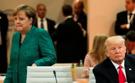 U.S. President Donald Trump, front right, and German Chancellor Angela Merkel, left, arrive for a working session at the G-20 summit in Hamburg, Germany, July 8, 2017. REUTERS/Markus Schreiber/Pool/File